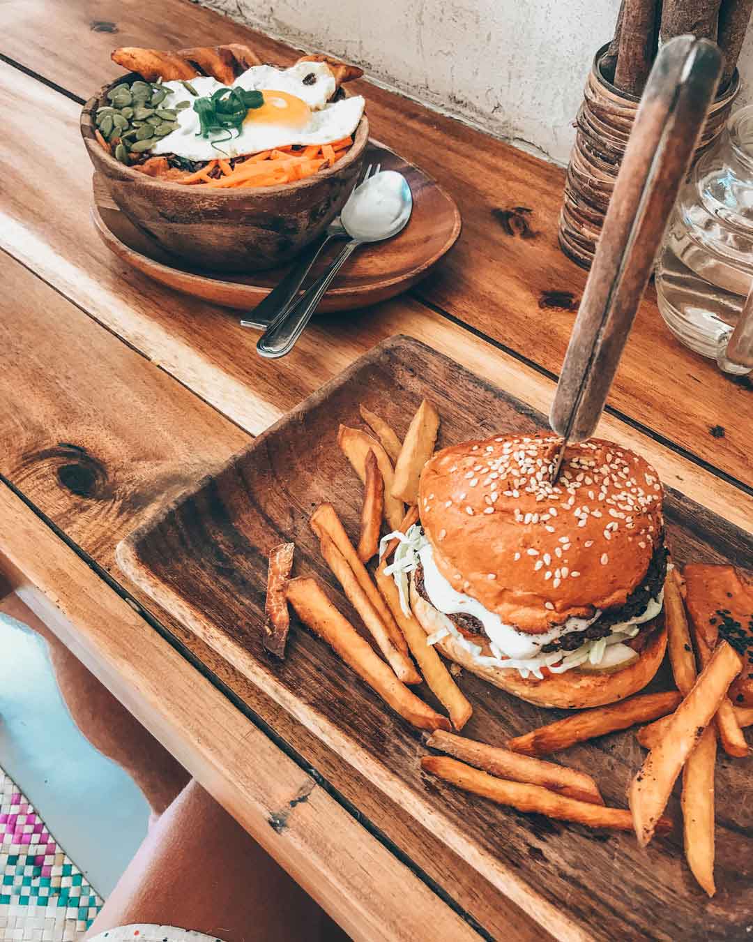hamburger with fries and a salad bowl