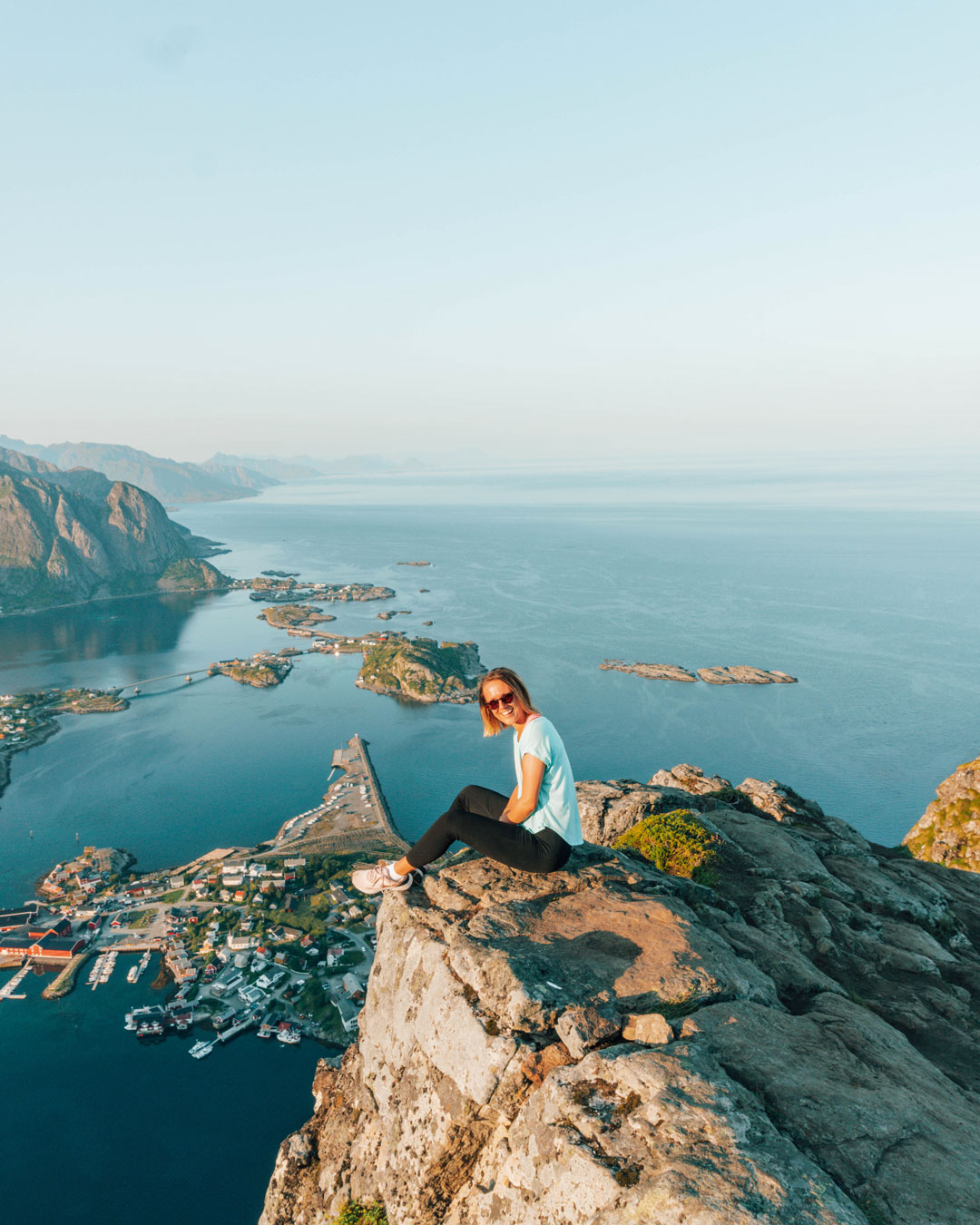 DSC04880_1080x1350 woman standing on a viewpoint with a fjord behind her